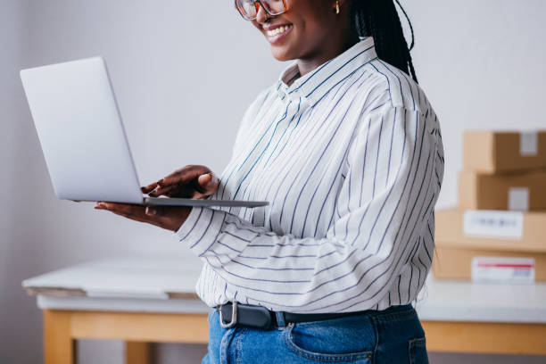 istock Smiling Woman Working on Laptop in Home Office 2156987624