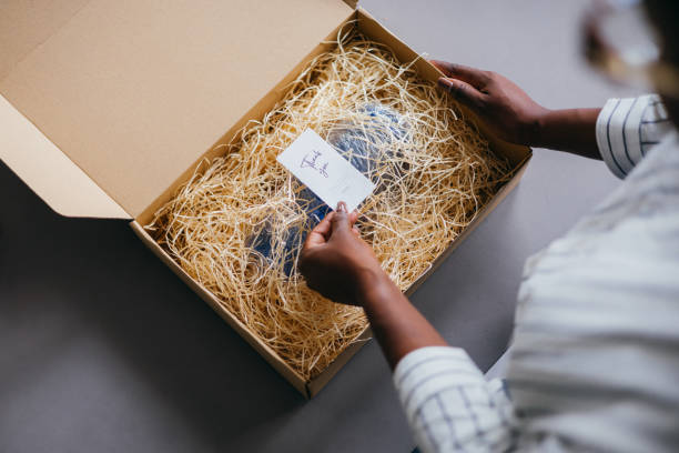 Woman Opening Package with Thank You Card in Box