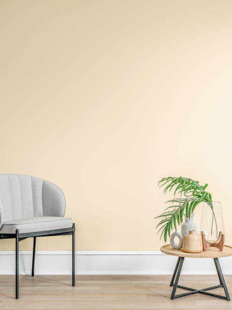 istock Cozy retro-chic interior with an art deco armchair and low coffee 
 table, yellow wall background, high baseboard, 50s- 60s decoration 2156992893
