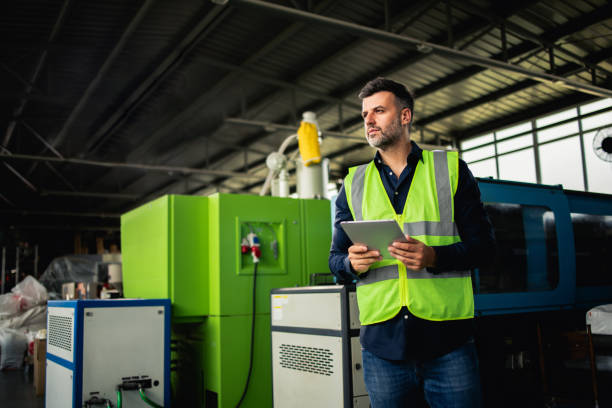 istock Worker at the factory controlling the industrial machines 2156992965