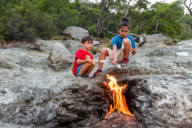 Boys Close-Up Roasting Marshmallows Over fire, Mount Chimaera in ancient Lycia, Antalya