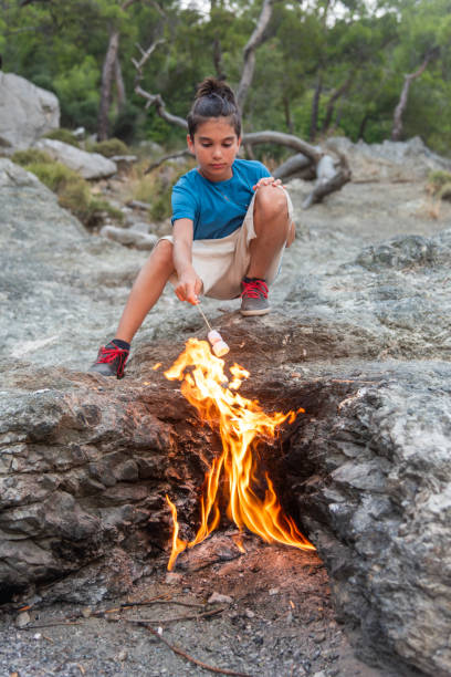 istock Boys Close-Up Roasting Marshmallows Over fire, Mount Chimaera in ancient Lycia, Antalya 2156993884