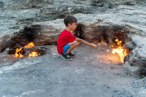 Boys Close-Up Roasting Marshmallows Over fire, Mount Chimaera in ancient Lycia, Antalya