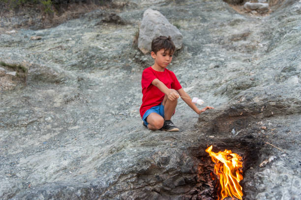 istock Boys Close-Up Roasting Marshmallows Over fire, Mount Chimaera in ancient Lycia, Antalya 2156993892