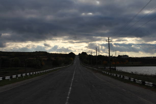 A road with a road and a cloudy sky. Sky. Outdoor. Scene. Way. Road