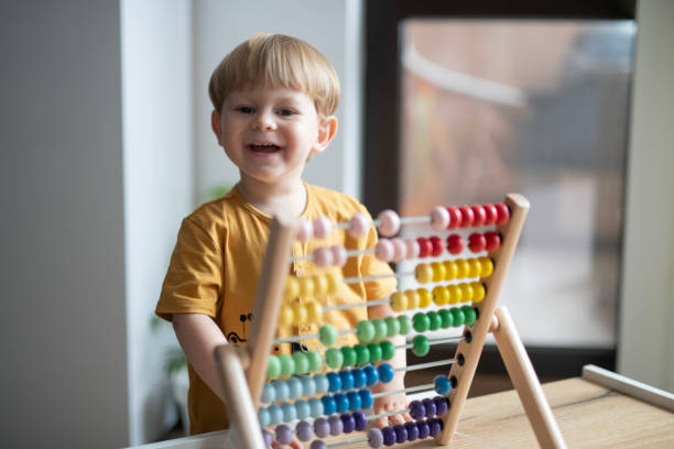 istock Portrait of a cute little boy playing with abacus. 2156997920