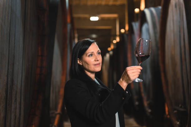 istock Woman in the wine cellar 2156998638