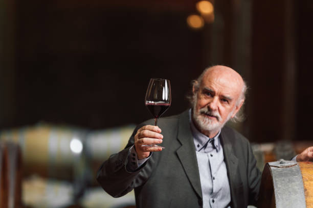 istock Man tasting wine, nodding head in approval and toasting 2157000224