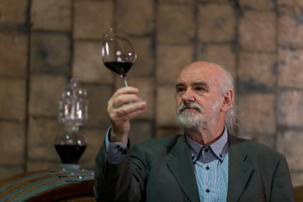 istock Man tasting red wine in a wine cellar 2157000888