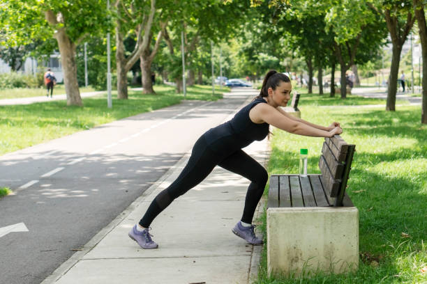 istock Young   woman doing physical exercises outdoors 2157001917