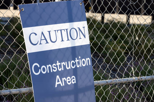 Close-up of the sign on the fence Caution, Construction area