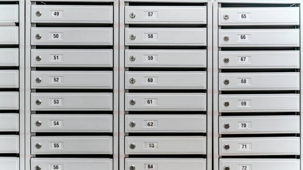 istock Rows of numbered mailboxes with locks. Organized and uniform appearance in metallic finish 2157004415