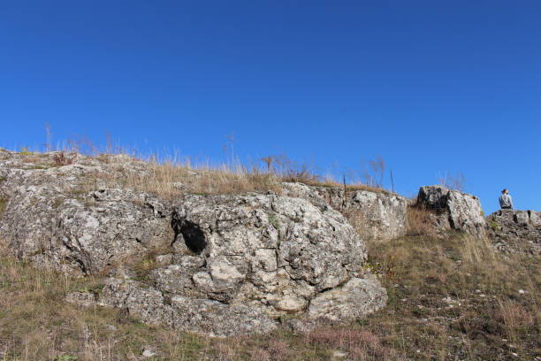 A stone wall with a person standing on top of it