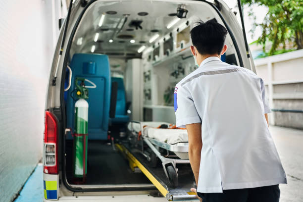 istock Paramedic pushing empty stretcher into ambulance outside hospital 2157005957