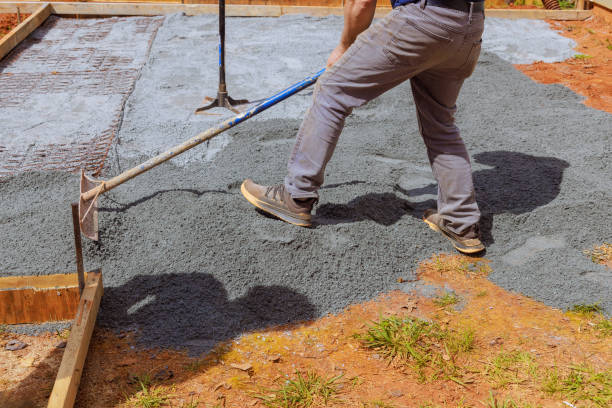 istock Construction work involves leveling ground, filling it with fine gravel stones, before pouring concrete into foundation of a house 2157005972