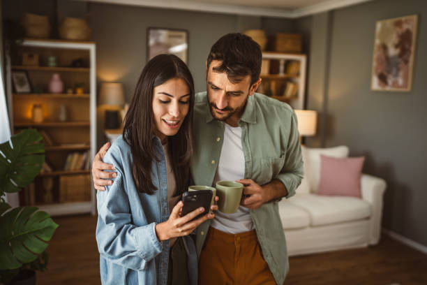 istock Couple use mobile phone for text message or browse internet at home 2157007793