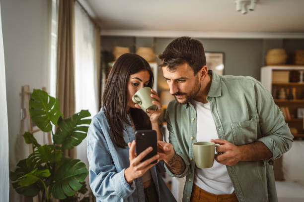 istock Couple use mobile phone for text message or browse internet at home 2157007932