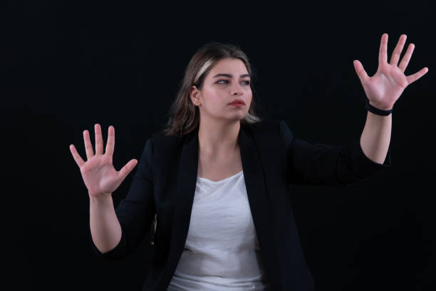 istock Woman using the virtual reality headset. Nice young woman using transparent screen, Technology concept. Black background. 2157008145