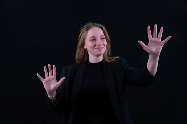 istock Woman using the virtual reality headset. Nice young woman using transparent screen, Technology concept. Black background 2157008264