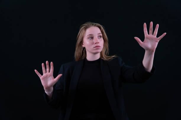 istock Woman using the virtual reality headset. Nice young woman using transparent screen, Technology concept. Black background. 2157008266