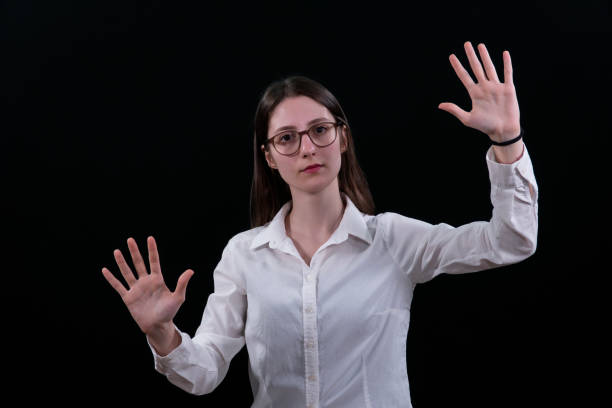 istock Woman using the virtual reality headset. Nice young woman using transparent screen, Technology concept. Black background. 2157008309