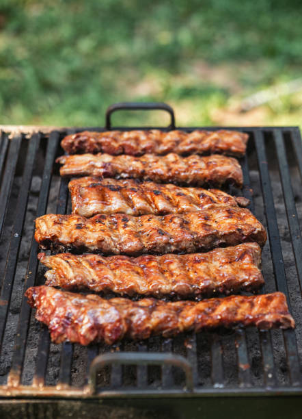 Preparing pork ribs on the barbecue grill in the backyard