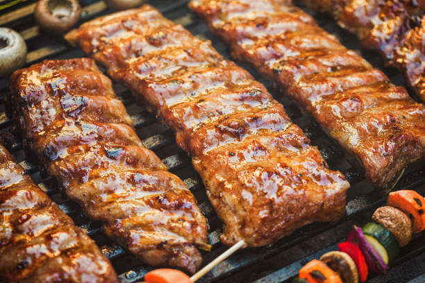istock Preparing pork ribs on the barbecue grill in the backyard 2157009010