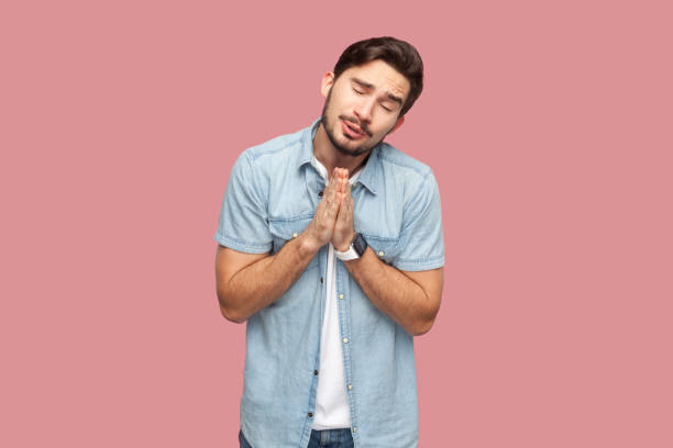 istock Hopeful sad man begs for forgiveness, keeps palms in praying gesture, asks mercy and says please. 2157014258
