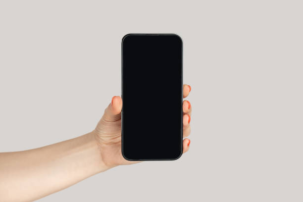 istock Woman hand showing mobile phone with blank screen, smartphonewith empty display, advertisement area 2157015197