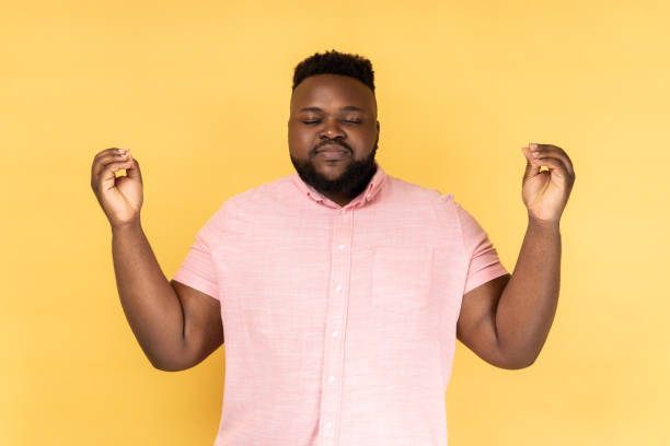 istock Man standing with raised arms and doing yoga meditating exercise, mudra gesture. 2157015320