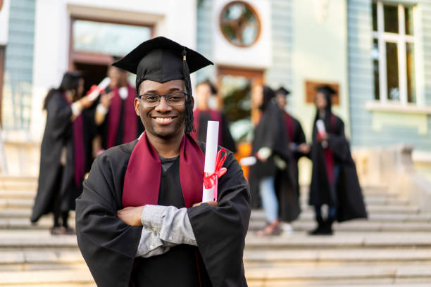 An alumnus holding his degree