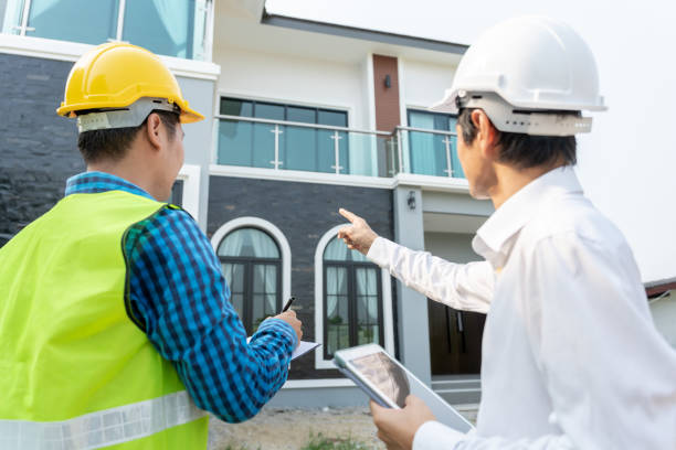istock inspector engineer and owner project is inspecting construction and quality assurance new house. Engineers or architects or contactor work to build the house before handing it over to the homeowner 2157015969