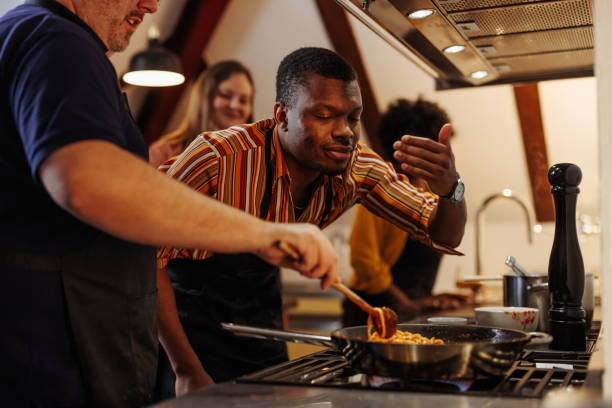 istock Man smelling food on stove 2157016619