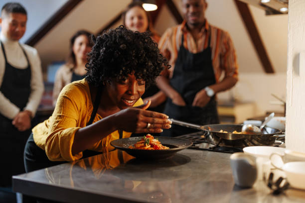 istock African American woman smelling a dish 2157016620