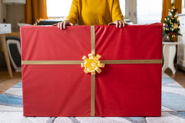 istock Holding with both hands a very large Christmas gift 2157018814