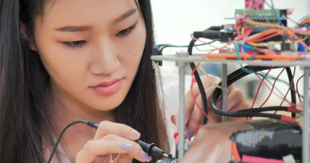 istock Asian Female Engineer Working on Robotics Circuit. 2157022666