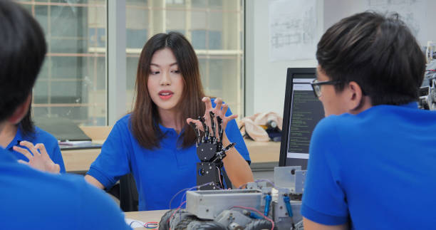 istock Asian Team Meeting Discussing Robotic Hand Project 2157022697