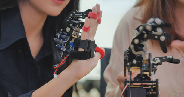 istock Asian Two Women Collaborating on Robotic Hand Project. 2157022711
