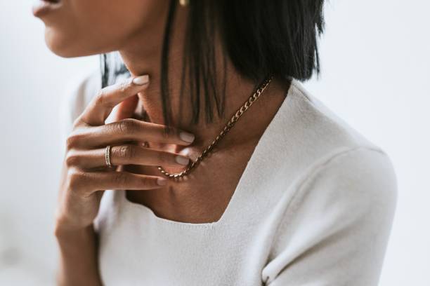 istock Woman touching her neck & gold necklace 2157022932