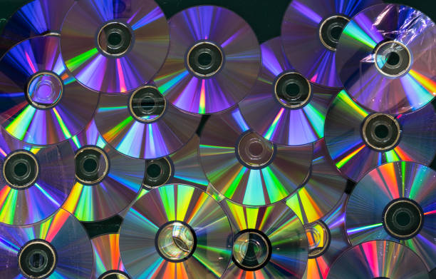 A collection of CDs with a rainbow effect