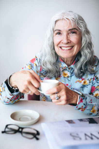istock Senior woman sipping coffee in a cafe 2157024268