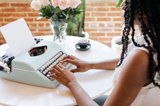 Woman typing on retro light blue pastel typewriter