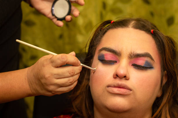 istock Applying colorful eyeshadow and makeup with brush on woman's face 2157025164