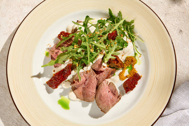 istock Still Life Roast Beef with Arugula, Sun-Dried Tomatoes, and Cheese Mousse in Natural Sunlight 2157026838