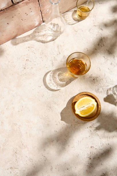 istock Sunlit Still Life with Citrus and Glasses on Beige Textured Table 2157026847