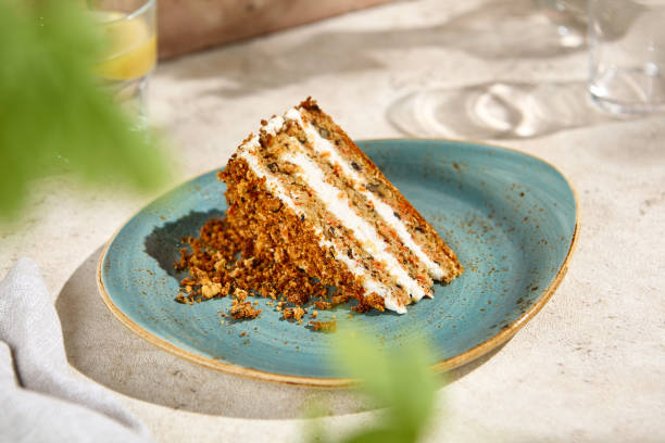 istock Authentic Carrot Cake Slice in Natural Sunlight Still Life on Beige Table 2157026954