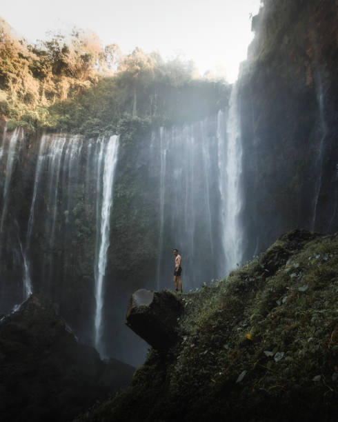istock Man standing by Tumpak Sewu Waterfalls, Indonesia 2157030002