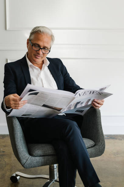 istock Senior businessman reading a newspaper 2157031148