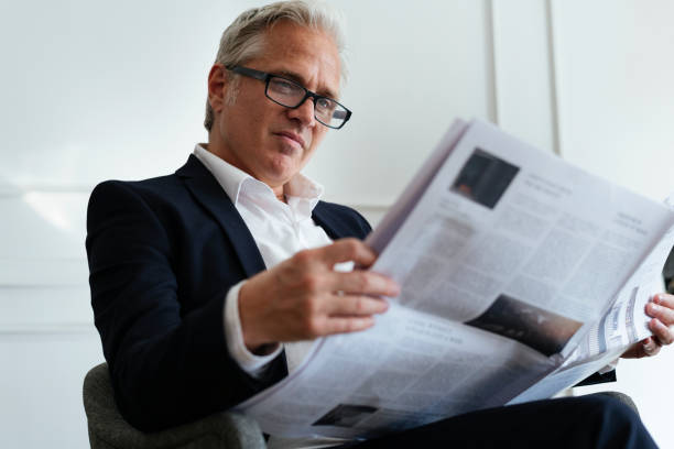 istock Senior businessman reading a newspaper 2157031151