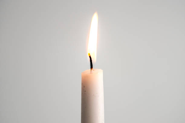 istock A white pillar candle burning for Christmas day 2157032360